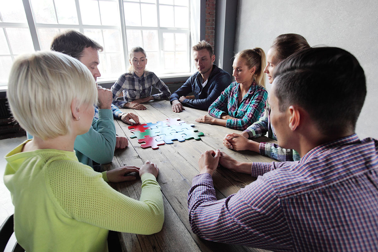 Business,People,And,Puzzle,On,Wooden,Table,,Teamwork,Concept