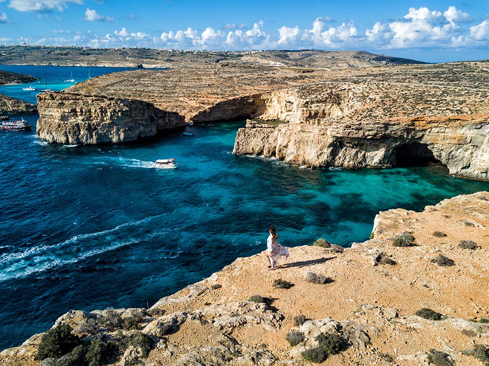 Aerial,Drone,Photo,-,Woman,Overlooking,The,Massive,Cliffs,Of